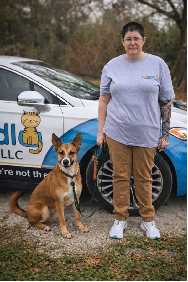 Furriendly Critter Sitters LLC team member with a dog outdoors.