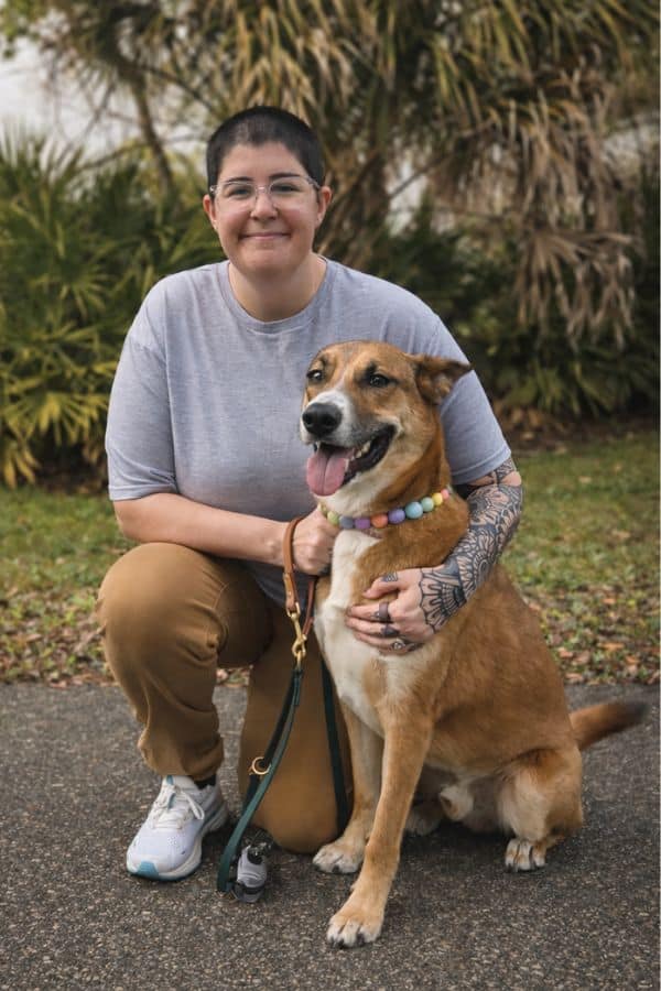 Jen veteran, animal lover, and the person behind every fur baby update you receive from Furriendly Critter Sitters with a dog posing for photo