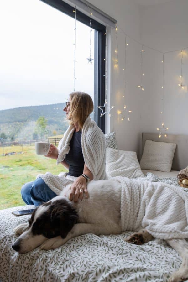 Pet sitter and dog looking out over a farm Live-In Pet Care (24-Hour) in Titusville, Mims & Northern Brevard County, FL​